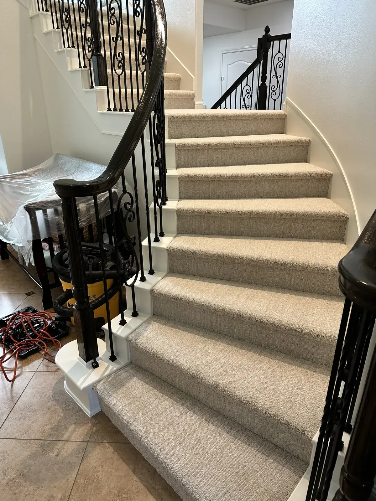 Carpet on a curved staircase with iron railings, Houston