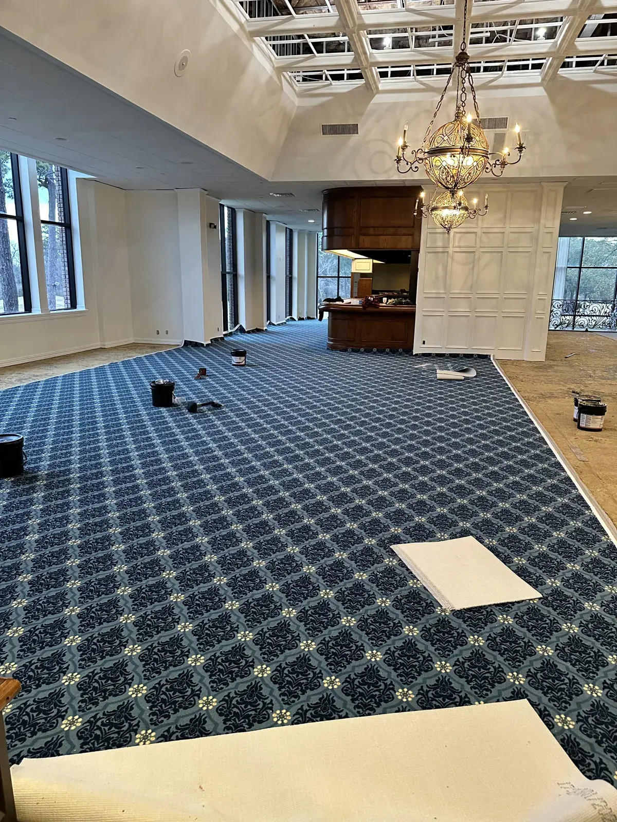 Patterned carpet being installed in a large event room in Champions, Houston