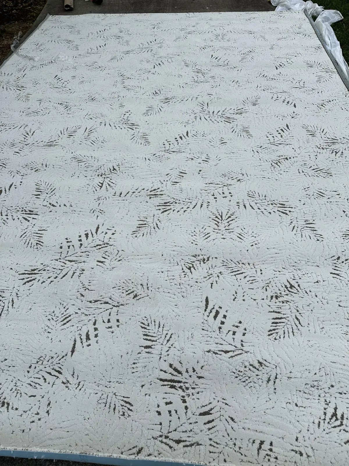 Leaf-pattern carpet cut and laid out, Houston