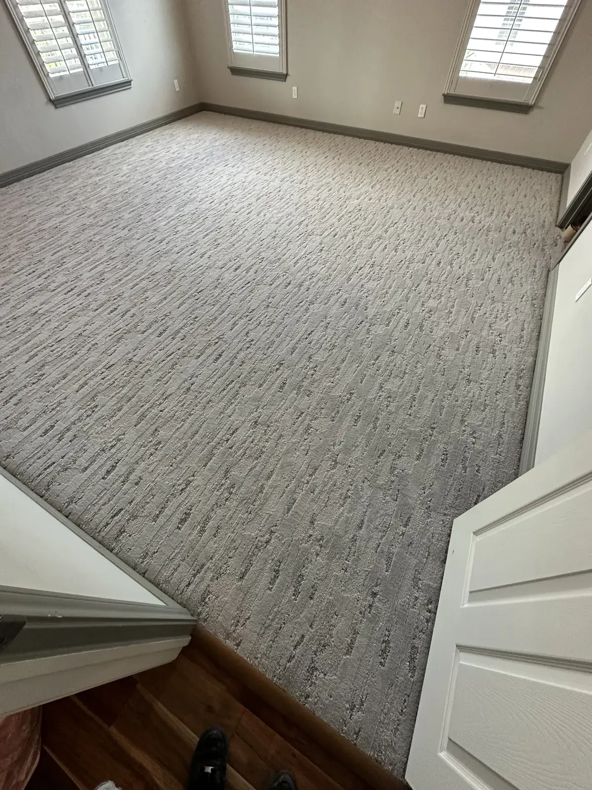 Newly installed patterned carpet in a bright room, carpet installation in Houston