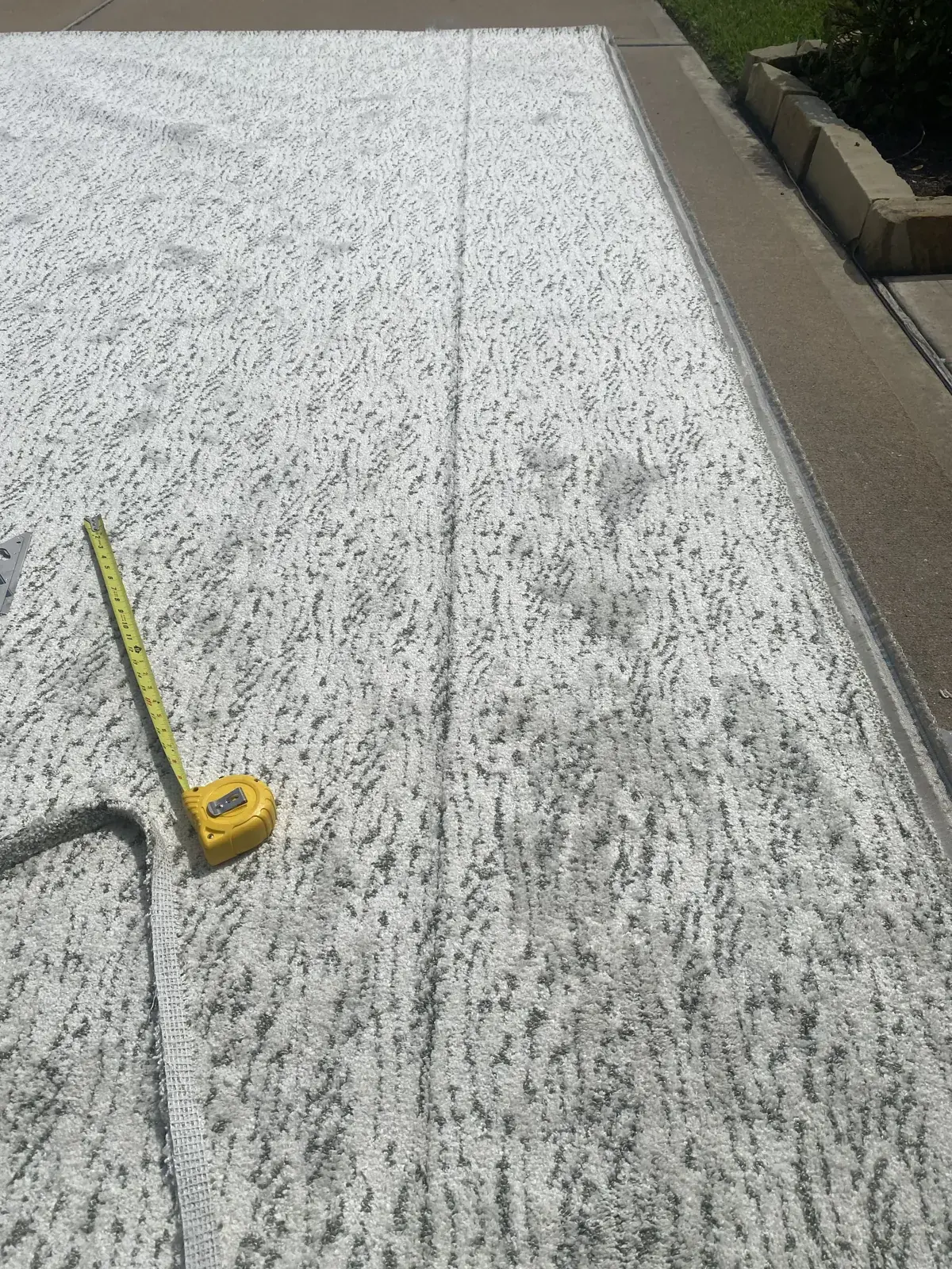 Measuring a carpet seam during installation in Houston
